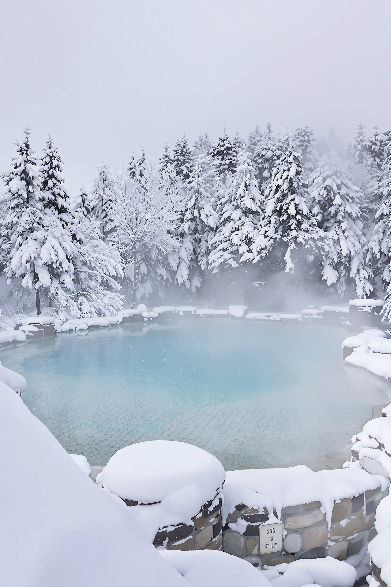 captivating view of a hot spring surrounded by snow in Hokkaido