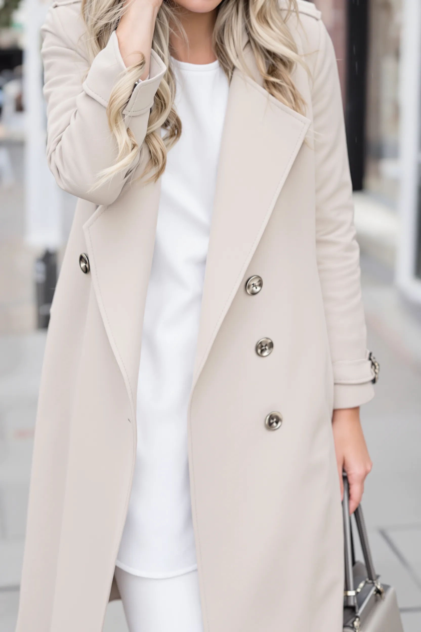 A classic beige trench coat styled over an outfit, perfect for a stroll in the rain